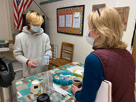 student at Coffee Cart serving Stillwater Superintendent Patti Morris