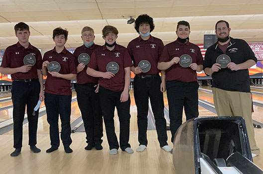 bowlers holding awards, standing together