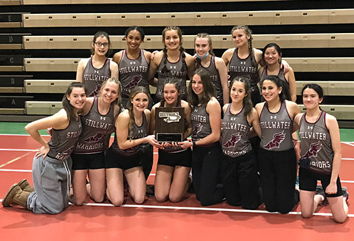 track team poses as a group, holding award