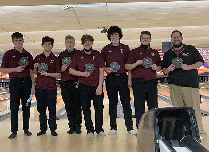 bowling team with coach holding awards from sectionals