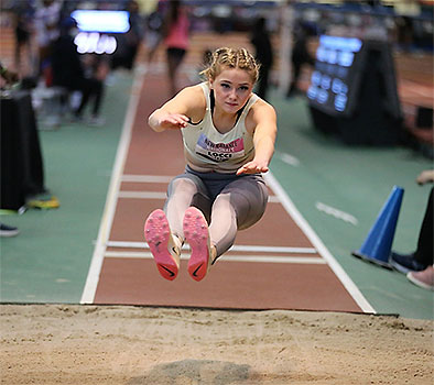 Gianna long jumping at New Balance Competition - photo by John Nepolitan