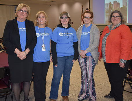 4 people wearing Women in Trades t-shirts and Assemblywoman Woerner