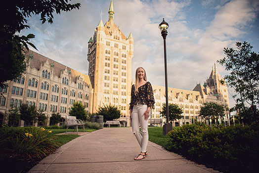 Paige Womble standing in front of the SUNY Administration Building
