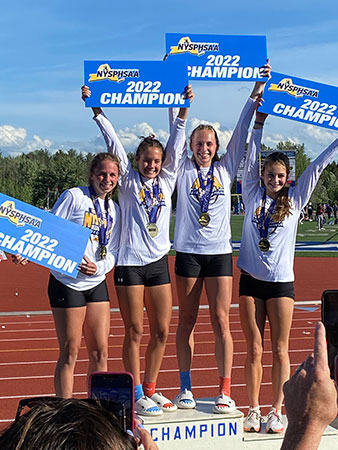 4 team members holding state champion signs