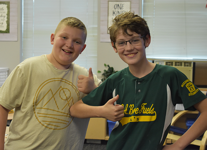 2 students, one with thumbs up