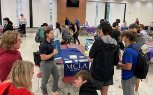 students and college reps in cafeteria at college caravan event