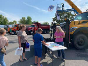 adults talking at a table at Touch a Truck Event