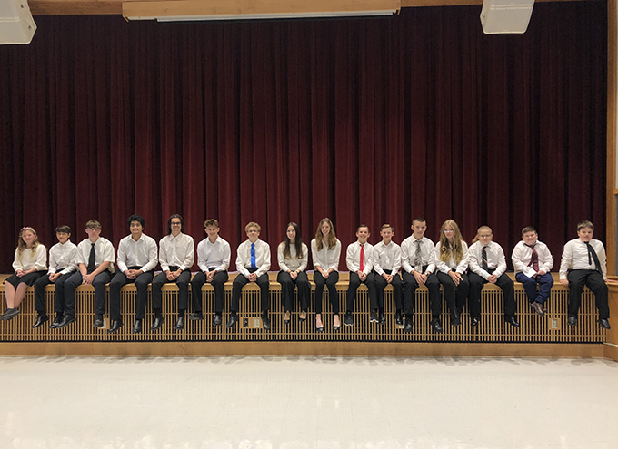 students sitting on stage