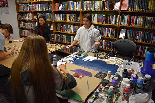 students painting posters