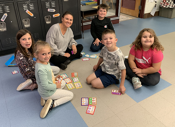 group of students with teacher and puzzles