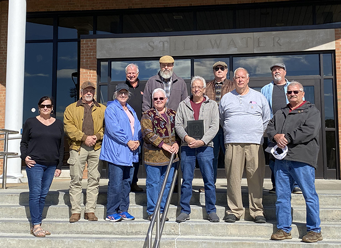 members of Stillwater Clas of 1972 standing outside HS entrance