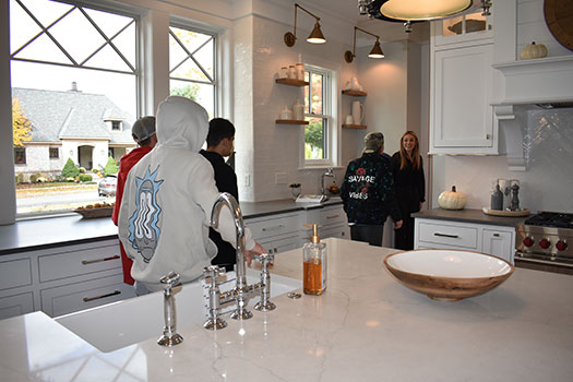 students touring kitchen of finished home