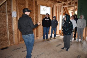 Nick Falco talking to students in home under construction