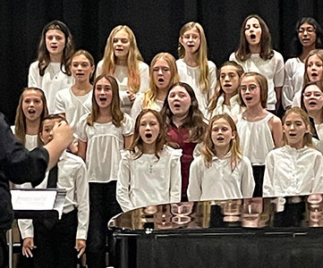 group of students standing and singing