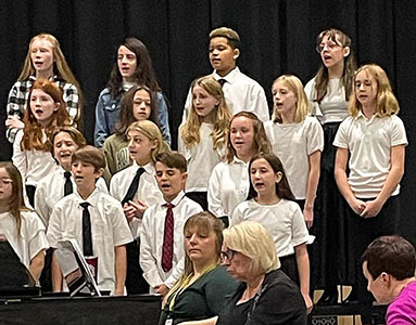 group of students standing and singing