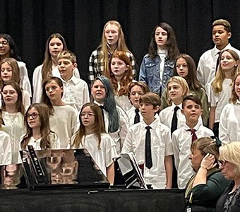 group of students standing and singing