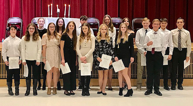 group of students standing in front of stage