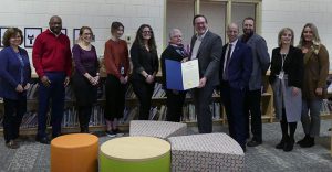 group of educators and officials, with Chris White holding proclamation