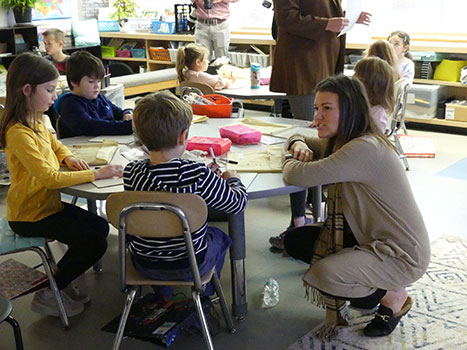 Madison Ramnes talking to students seated at a table