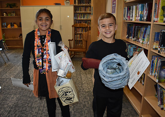 2 students holding their buckets