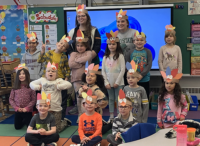 students wearing paper Thanksgiving hats