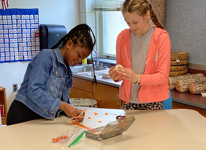 2 students work on a STEAM project