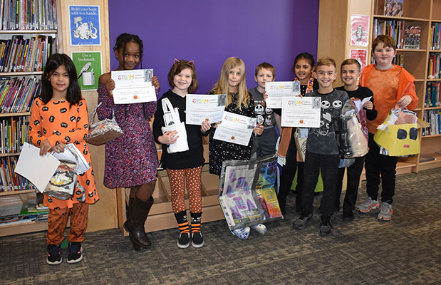 group of students holding their buckets and certificates