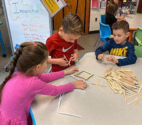 students working with popsicle sticks