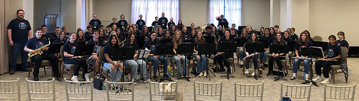 large group of seated student musicians in the 2022 NEIMF All-Star High School Concert Band