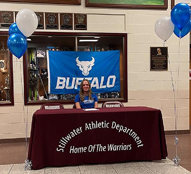 Kara seated at table