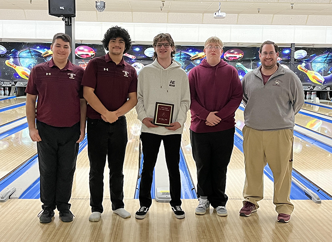 Bowling team members and coach at bowling alley