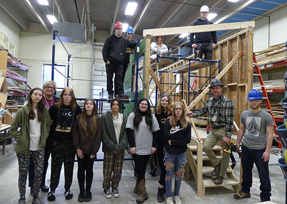 group of students and principal in construction classroom