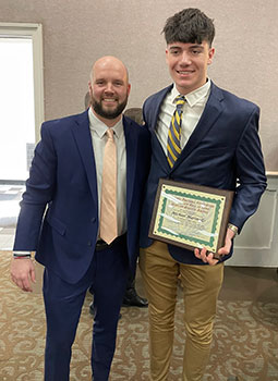 Coach Godfrey and Michael Marinello, holding his plaque