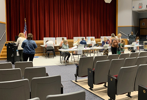 people voting in the auditorium