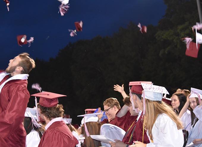 graduates tossing their hats