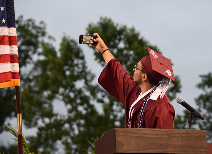 Salutatorian taking a selfie of the entire graduating class 