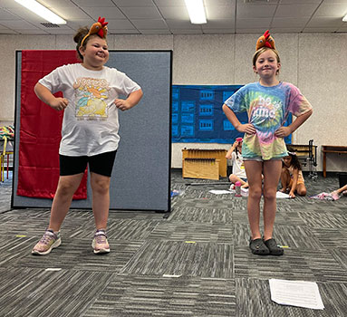2 students wearing chicken hats