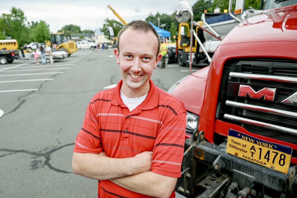 Man smiling with his arms crossed.