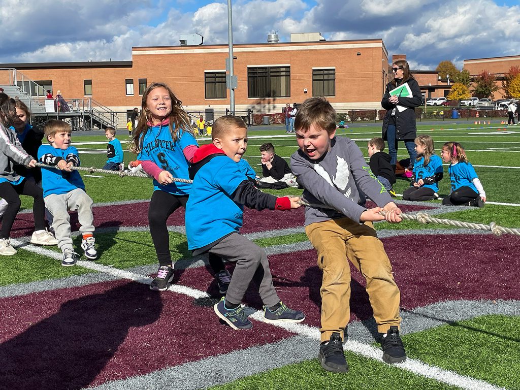 Elementary students pulling the rope as part of "Tug of War."