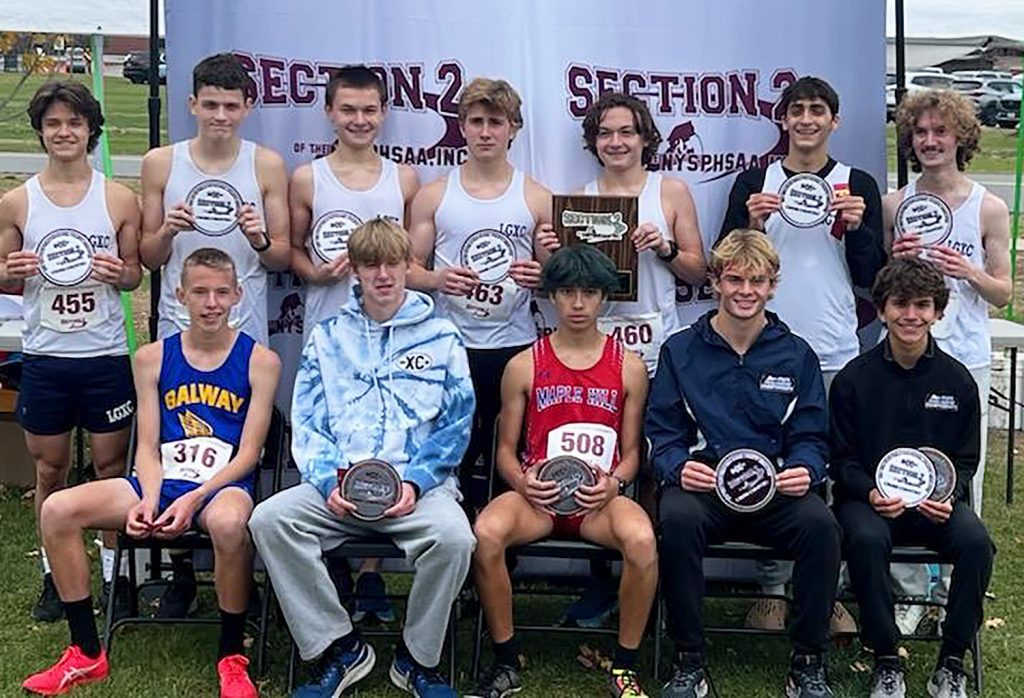 Group of runners who won awards smiling for a group photo.