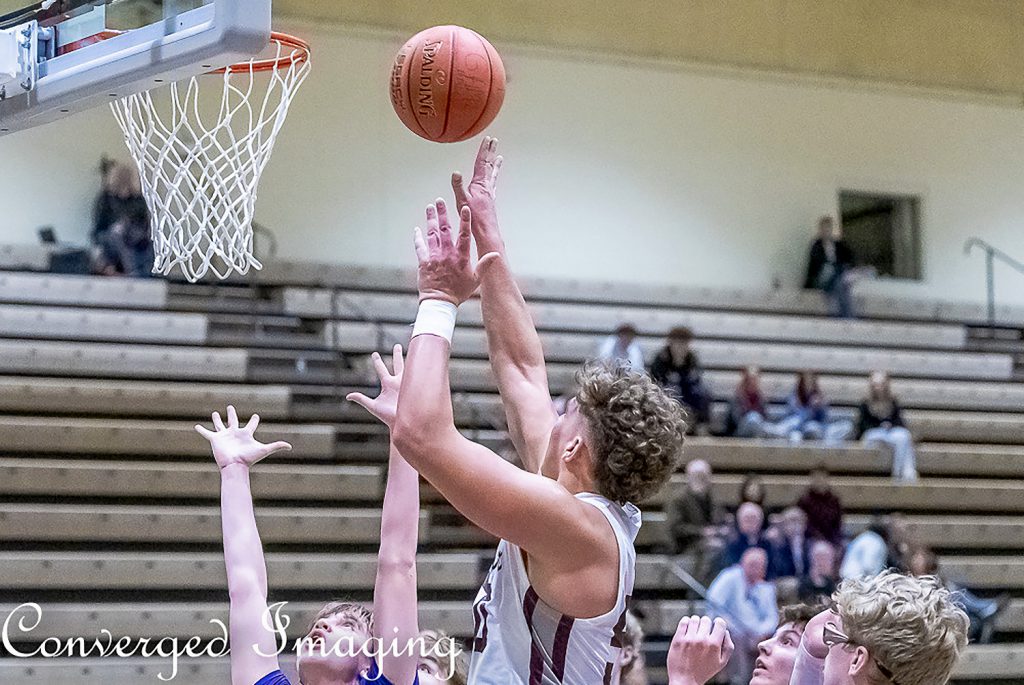 Basketball player reaching for basketball.