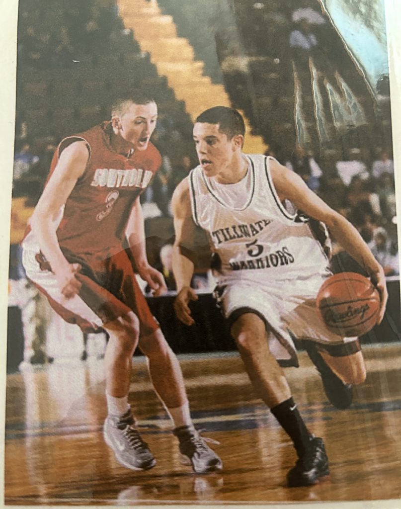 Two basketball players playing on the court.