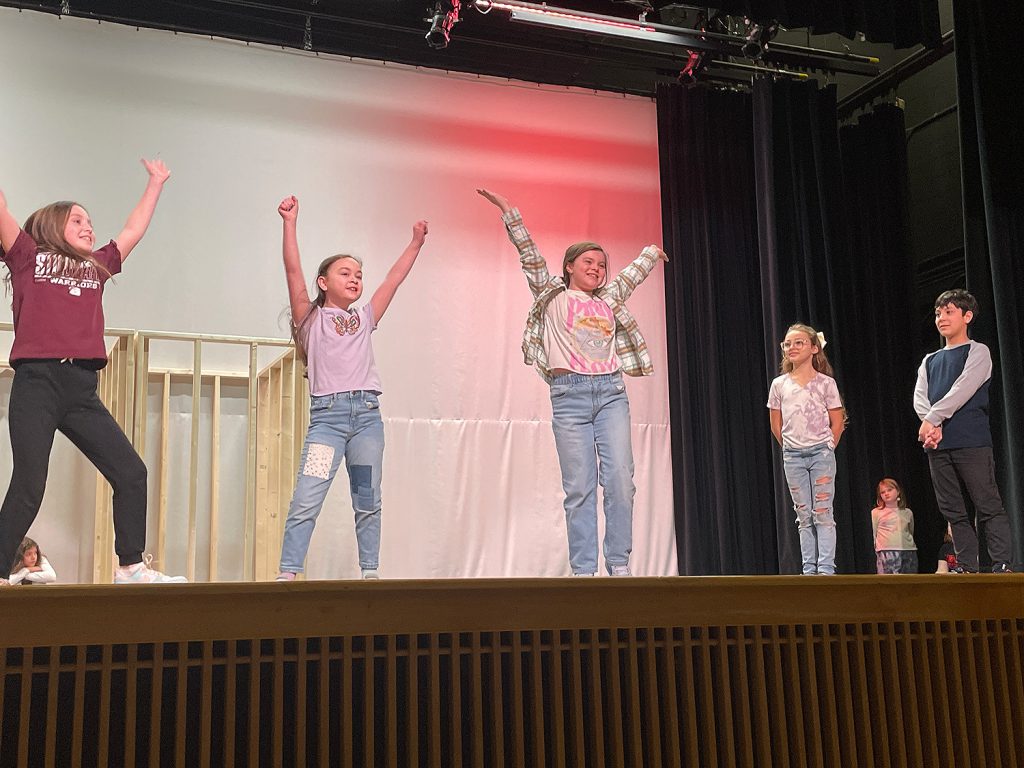 Students dancing on stage.