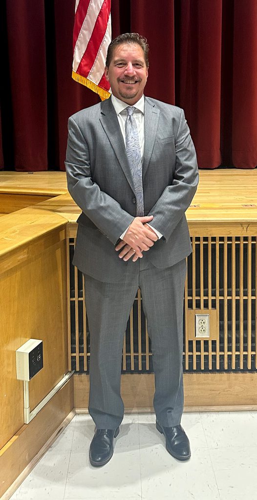 Man standing and smiling.