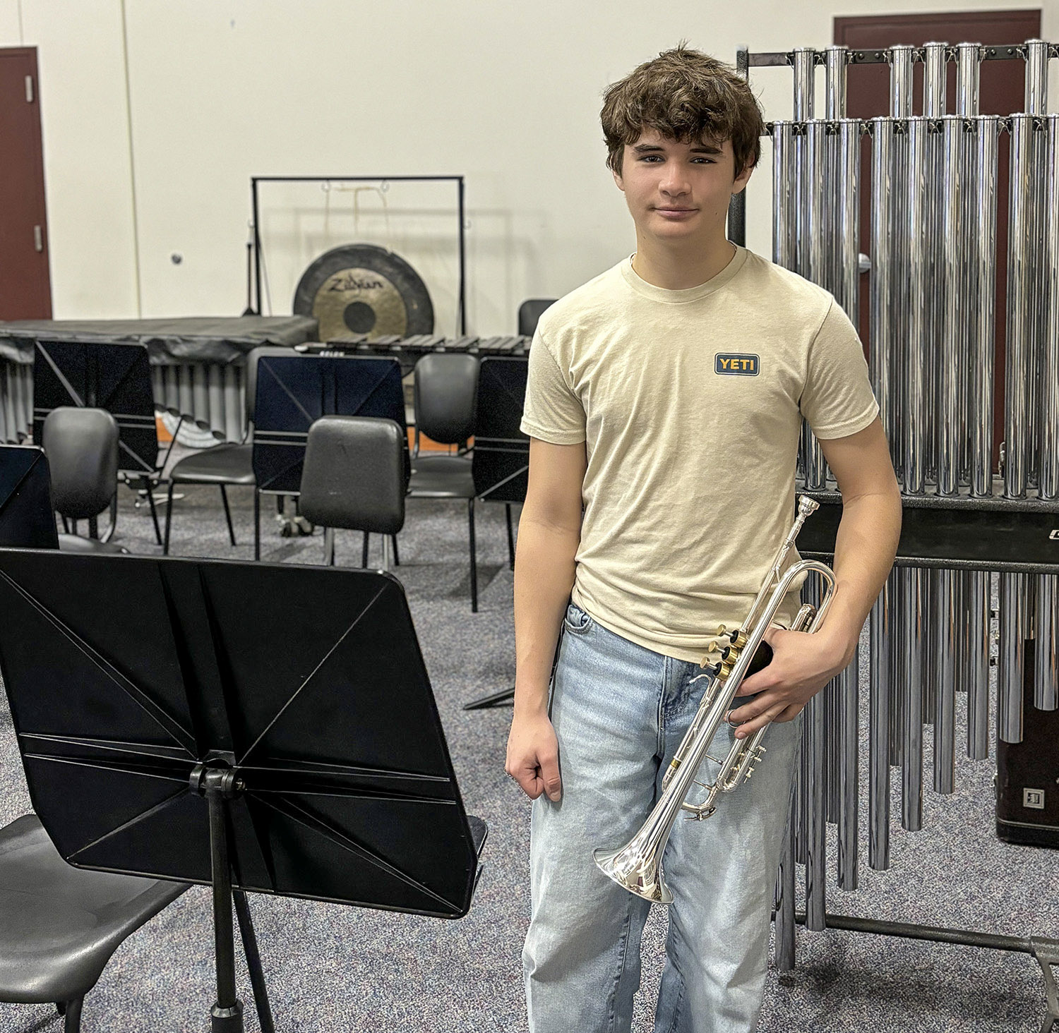 Student posing with trumpet.