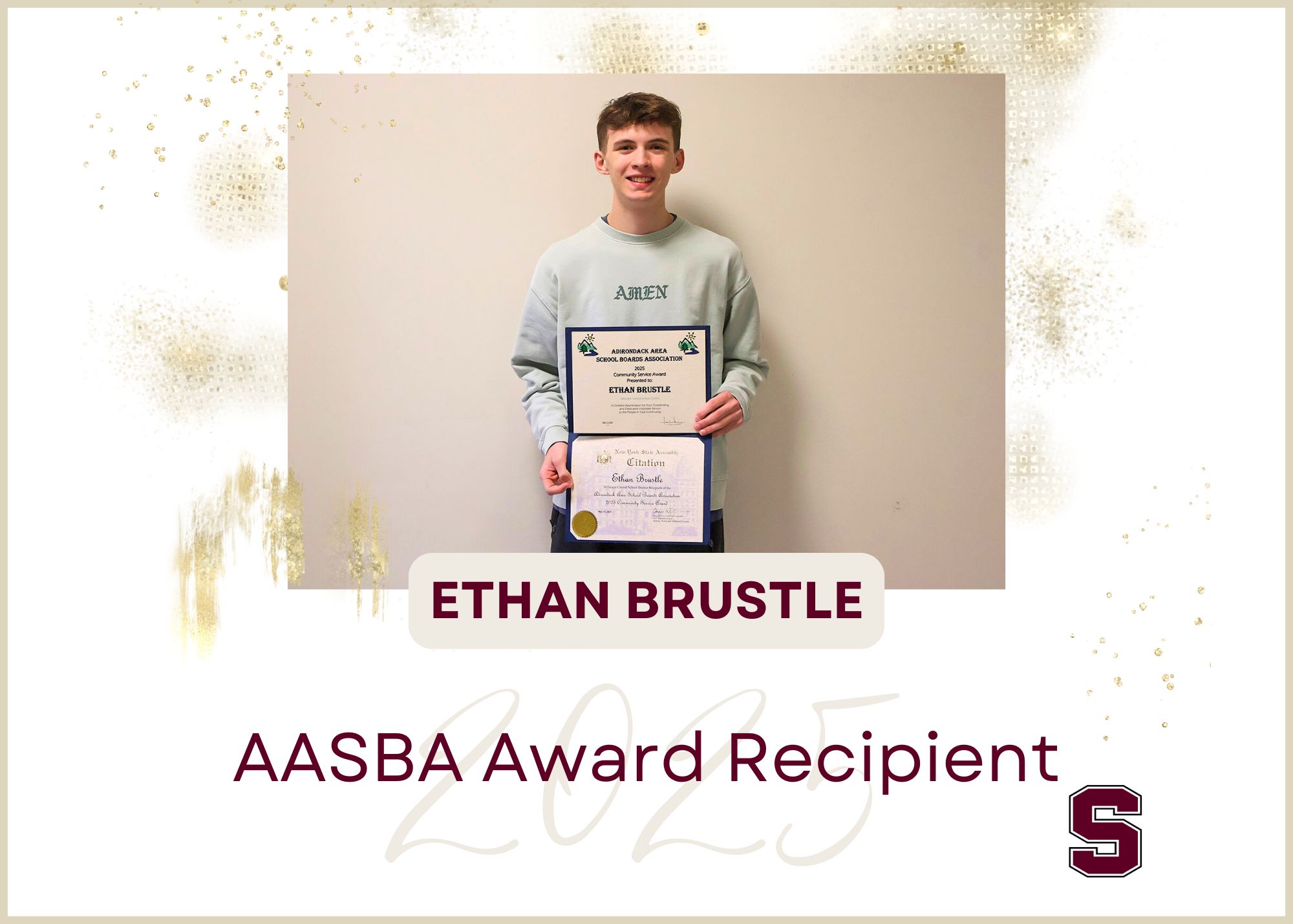Student Ethan Brustle presenting the AASBA Award in hand smiling at the camera.