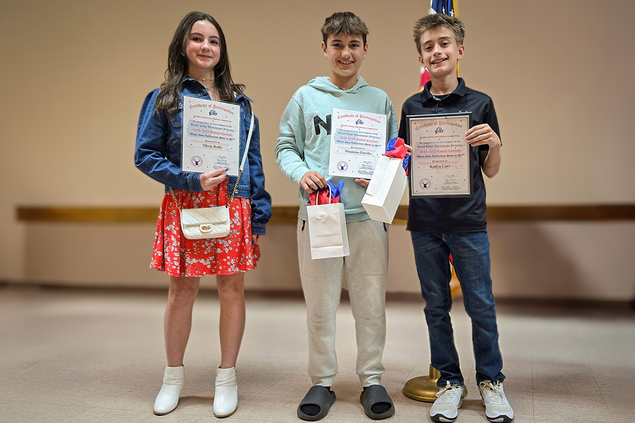 3 Students standing with Awards in hand.