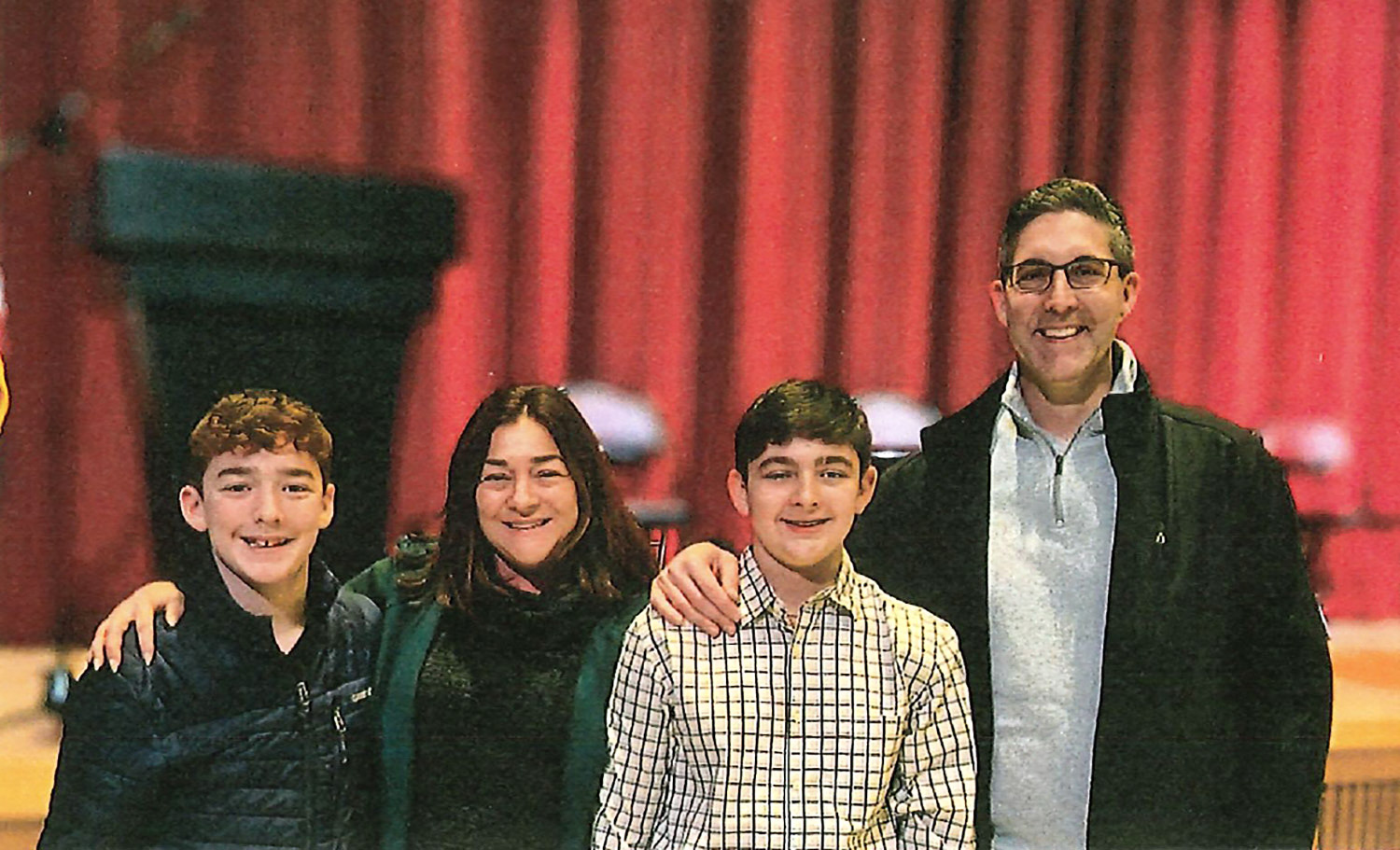 Tara Gutman smiling with family.
