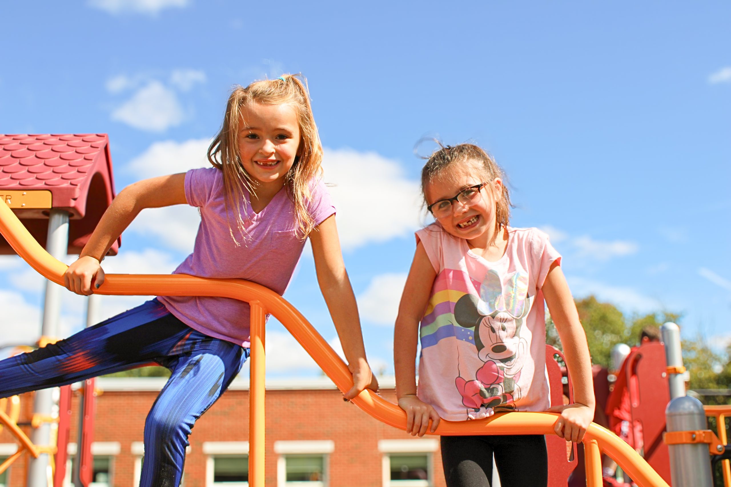 two students smiling at the playground