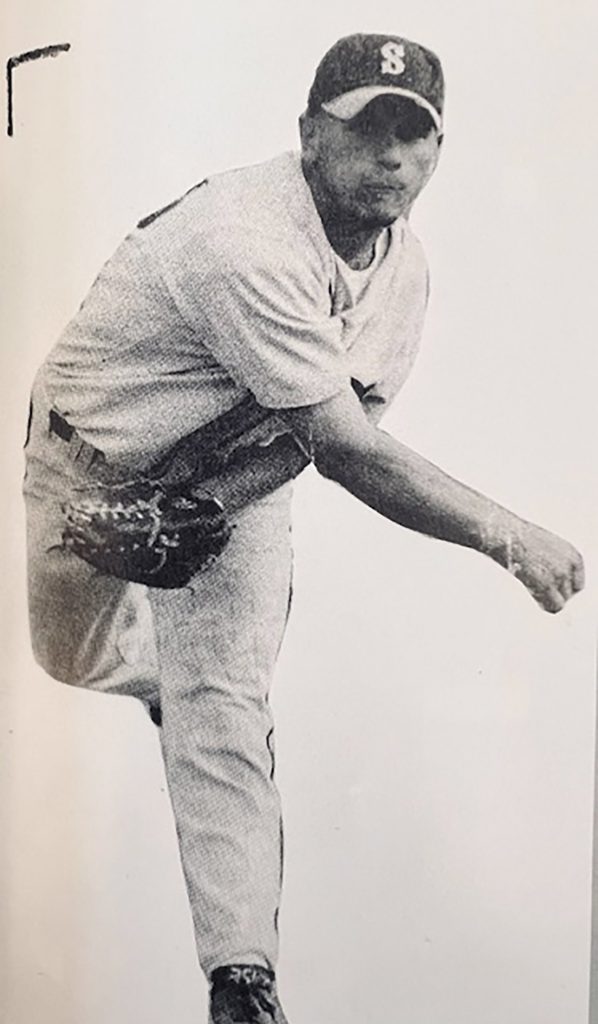 Photo of Baseball player after throwing a ball.